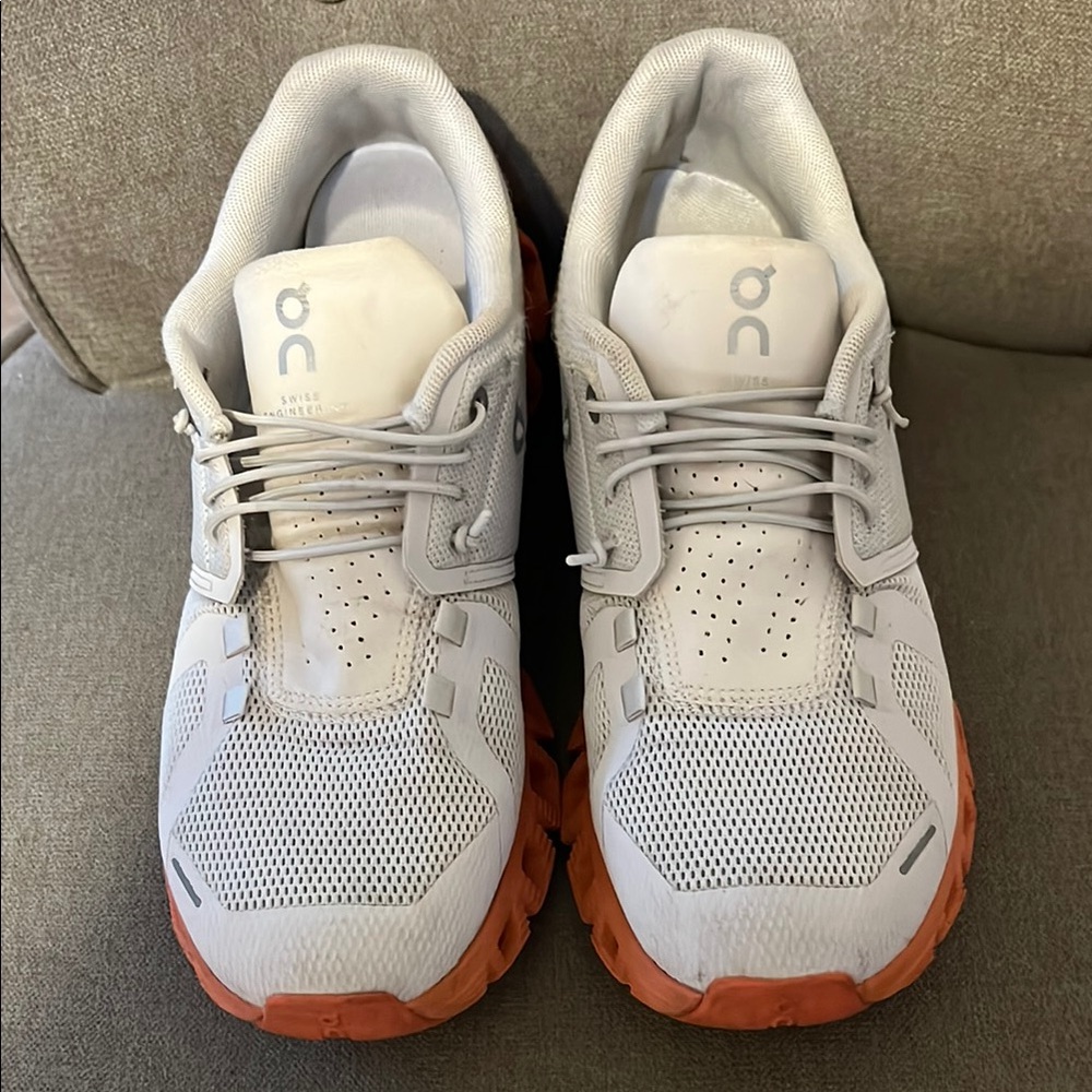 On Running White and Orange Sneakers